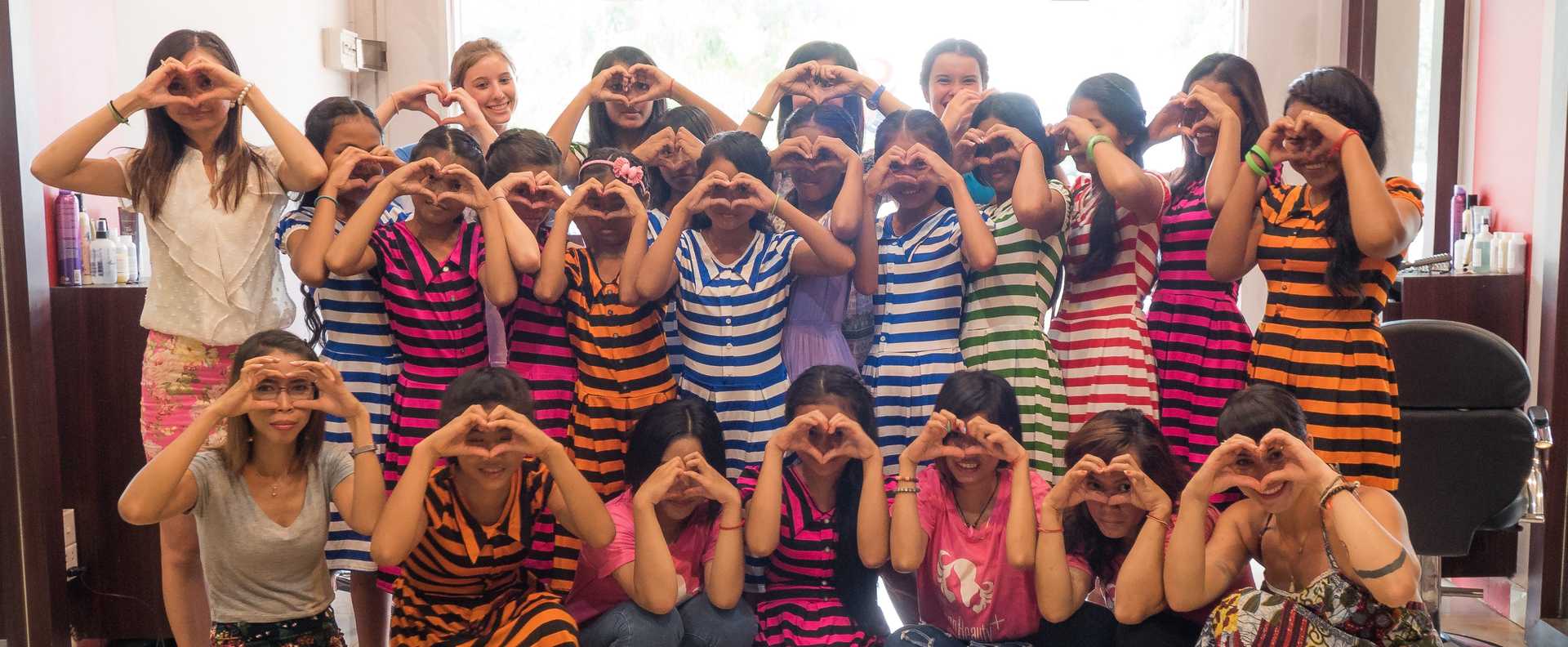 Group of students making heart shapes with their hands